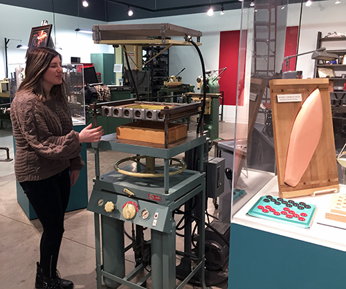 Olivia Viktora looks at a thermoforming press, which pressed plastic sheets, invented by late UW-Stout Chancellor Bob Swanson