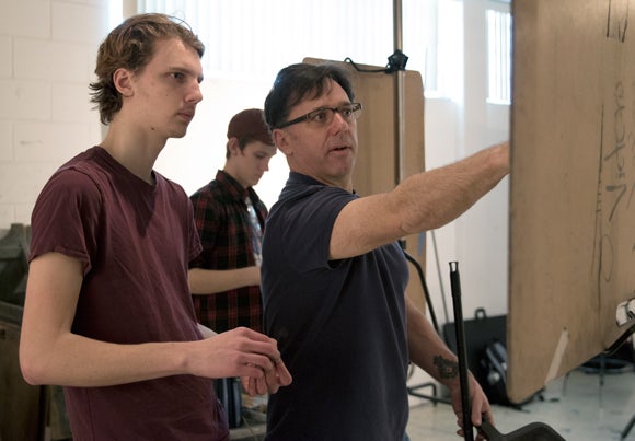 Assistant Professor Daniel Atyim, right, works with a student in a Drawing II class in February.