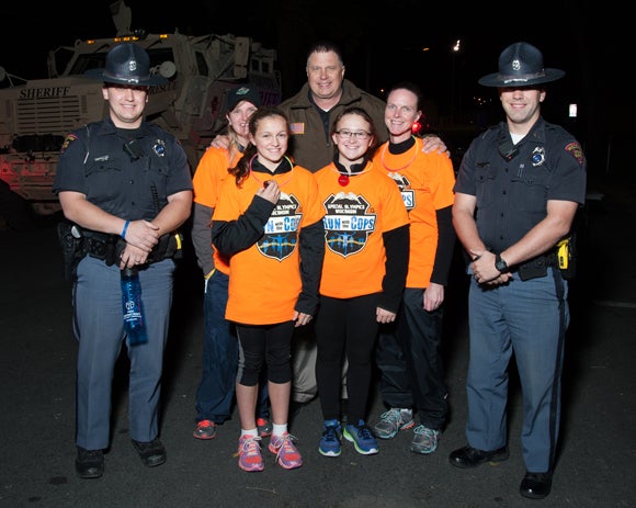Police officers and runners take part in the 2015 Run With the Cops event at UW-Stout.