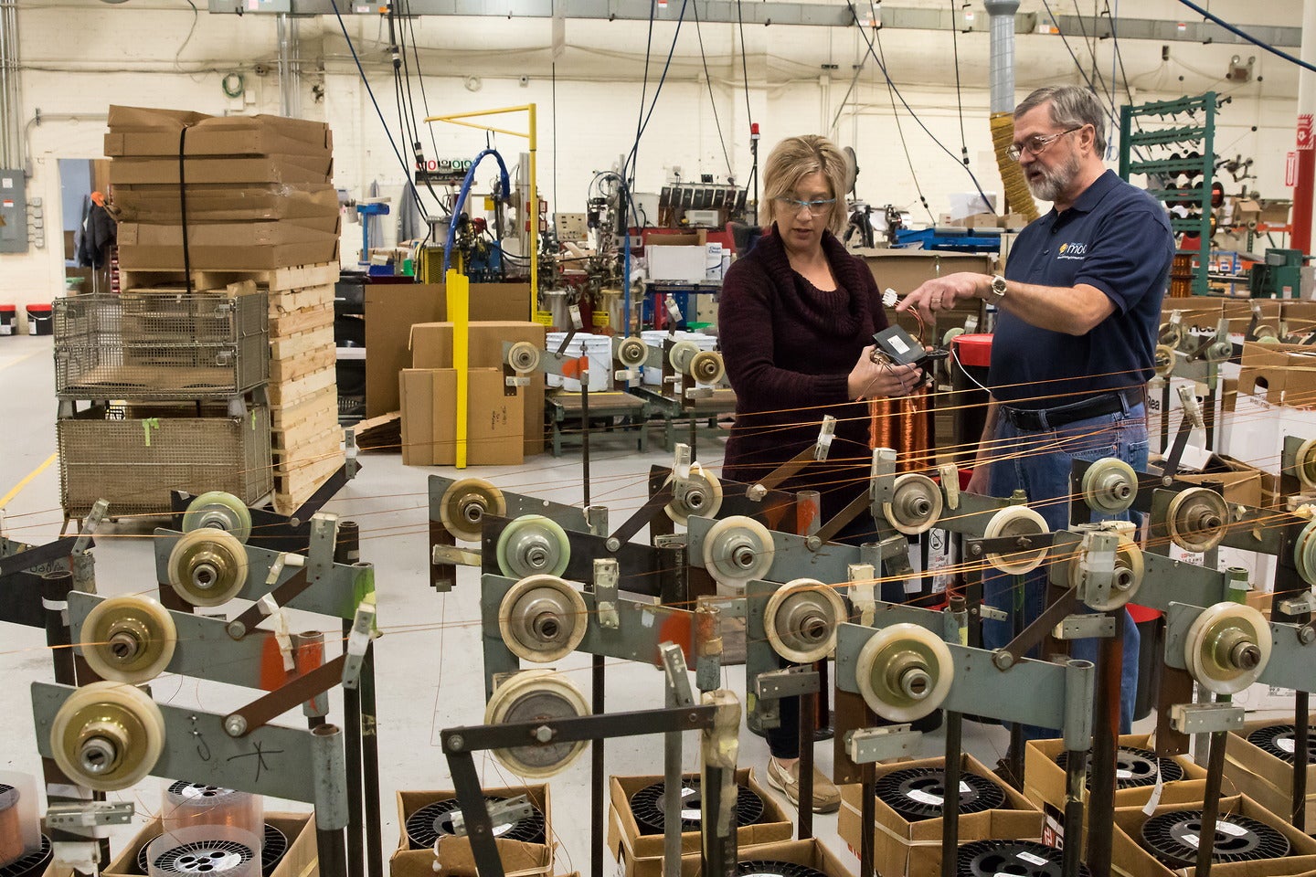 Bill Amsrud, Operations Manager at the UW-Stout Manufacturing Outreach Center, works with Julie Berndt, V.P. Operations at Johnson Electric Coil Company in Antigo, Wisconsin, on lean manufacturing implementation.