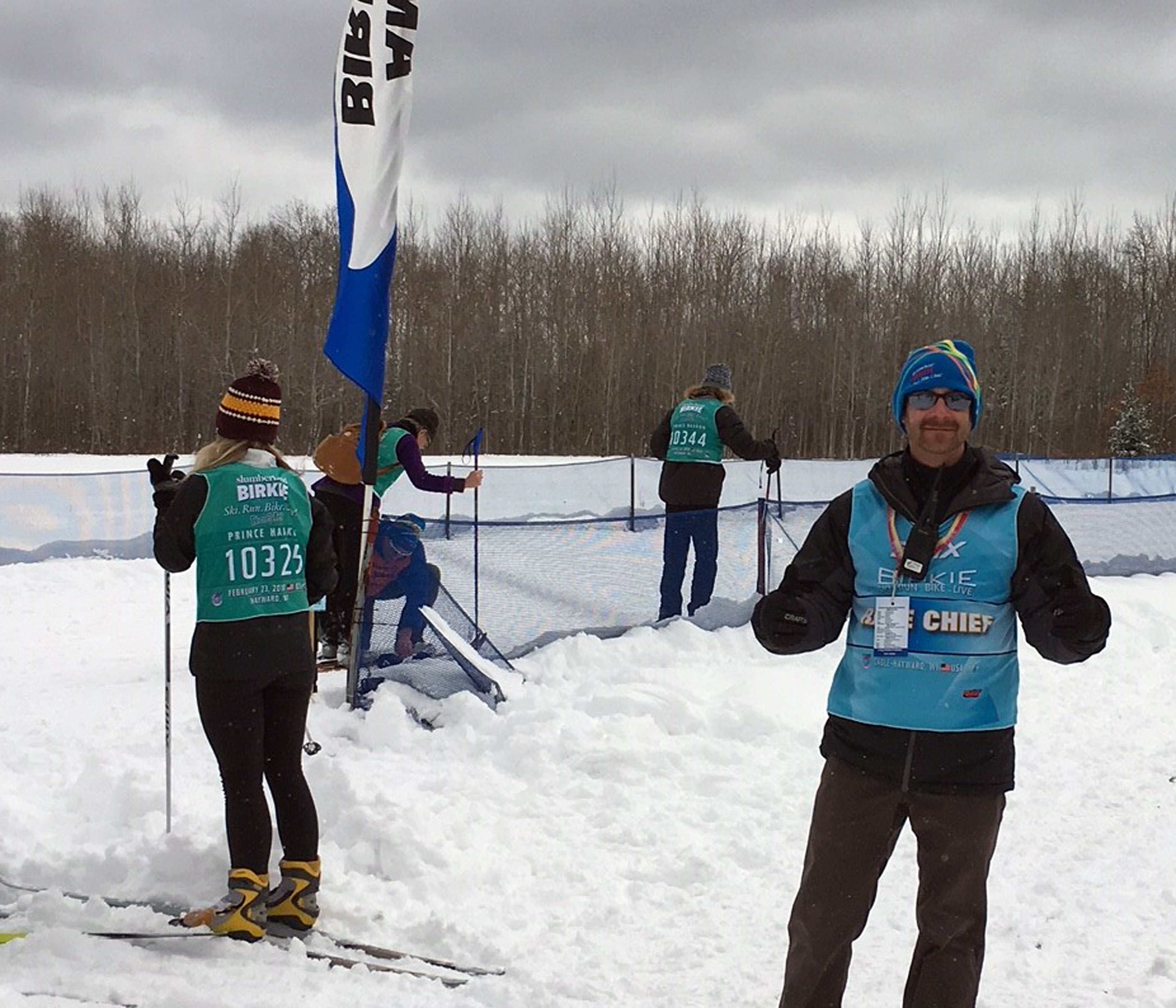 Jesse Cain, a UW-Stout alumnus, helps at the start of the Prince Haakon cross-country ski race Friday, Feb. 23, at the American Birkebeiner.