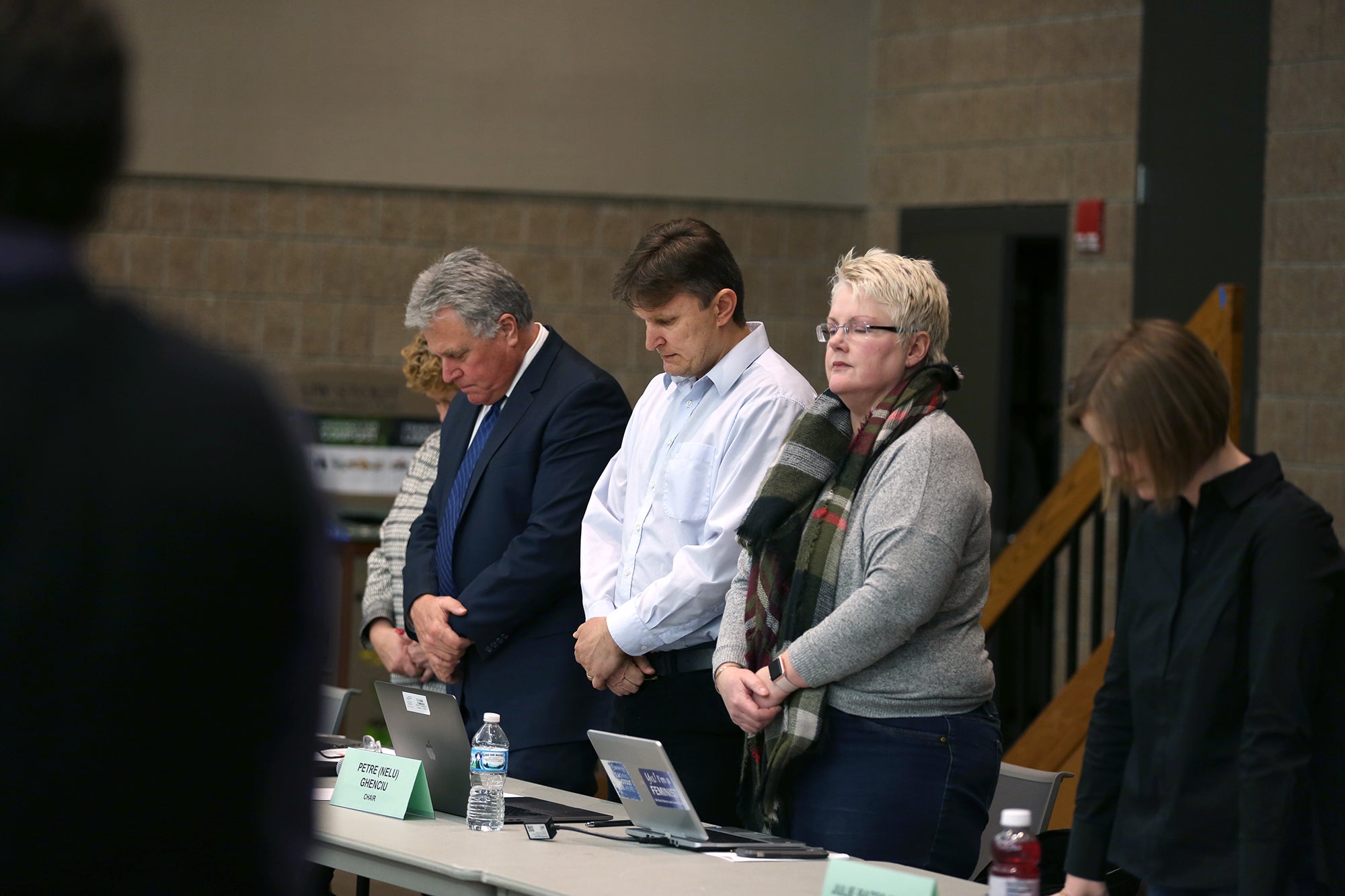 UW-Stout Faculty Senate Chair Petre “Nelu” Ghenciu, at center, with Chancellor Bob Meyer, at left, and senate Secretary Glenda Jones, observe a moment of silence for Chancellor Emeritus Charles W. Sorensen. UW-Stout Photo by Brett T. Roseman