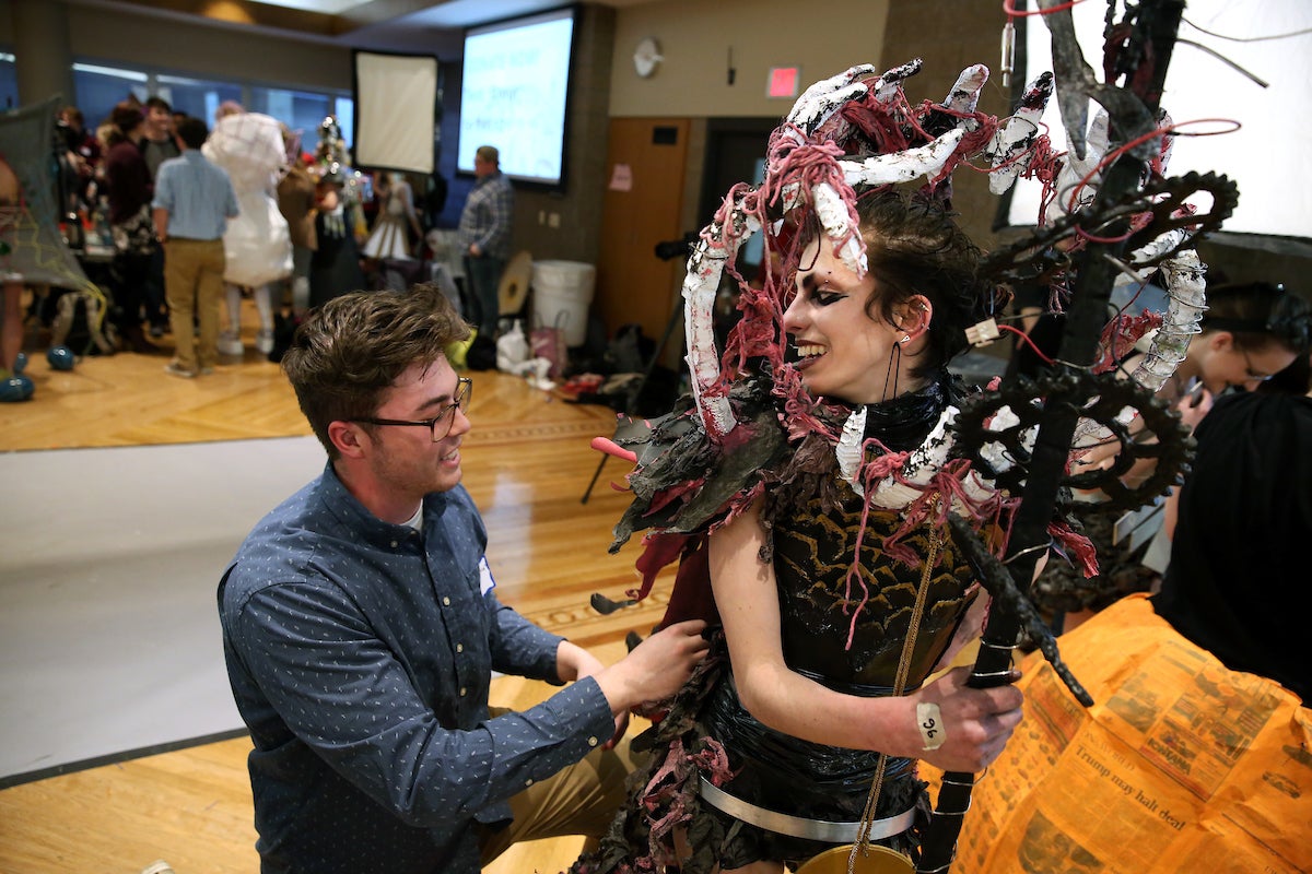 Alice O'Brien and Patrick Brunker putting the final touches on their design "Consuming Bellows" in the MSC Ballrooms before the show.