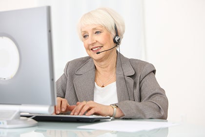 Photo of business woman working on a computer.