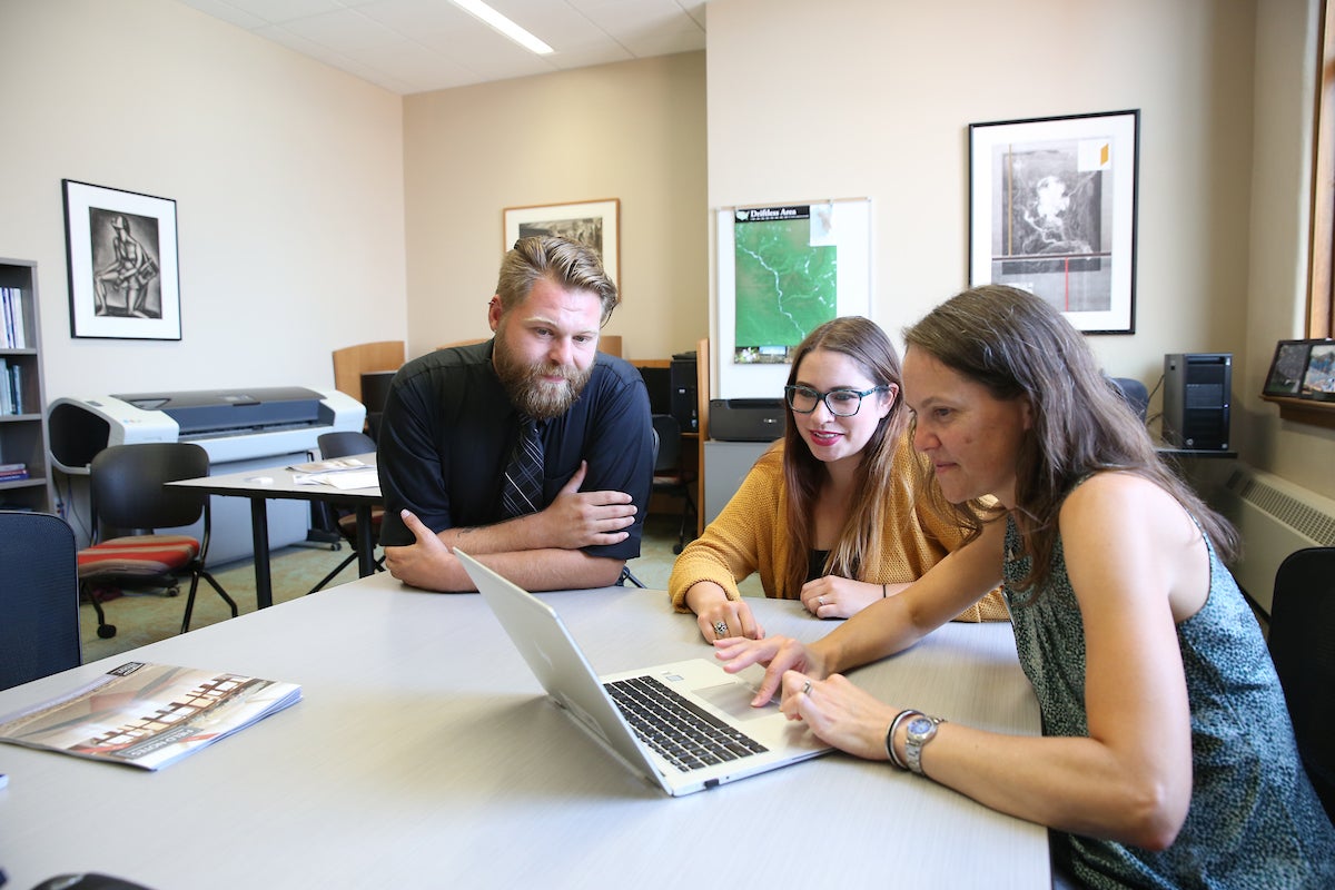 Applied Social Sciences students Ryan Leckel and Elle Alvarez, and Associate Professor Tina Lee in the Social Science Research Center in Harvey Hall.