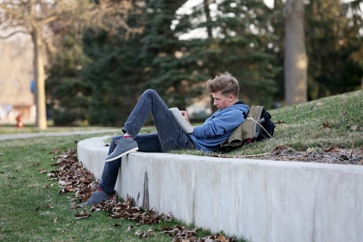 Student studying outdoors at UW-Stout.