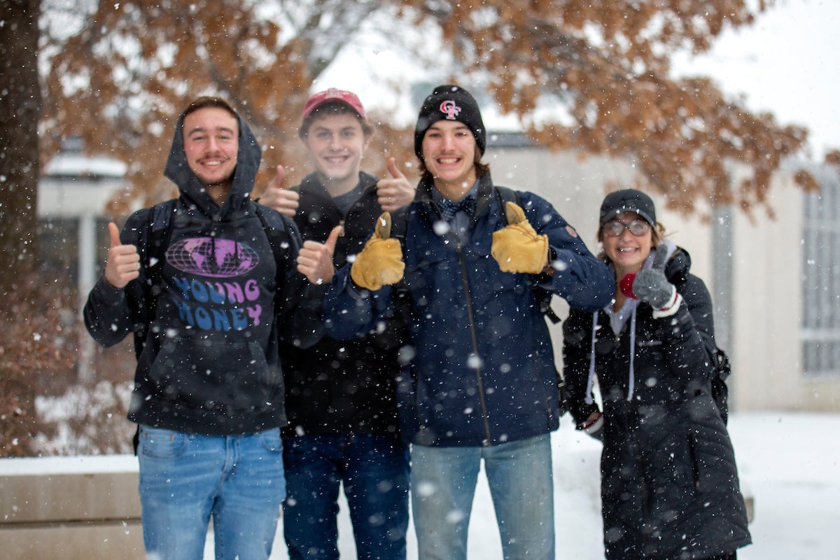 Students on campus deal with a heavy snowstorm while going to and from class.