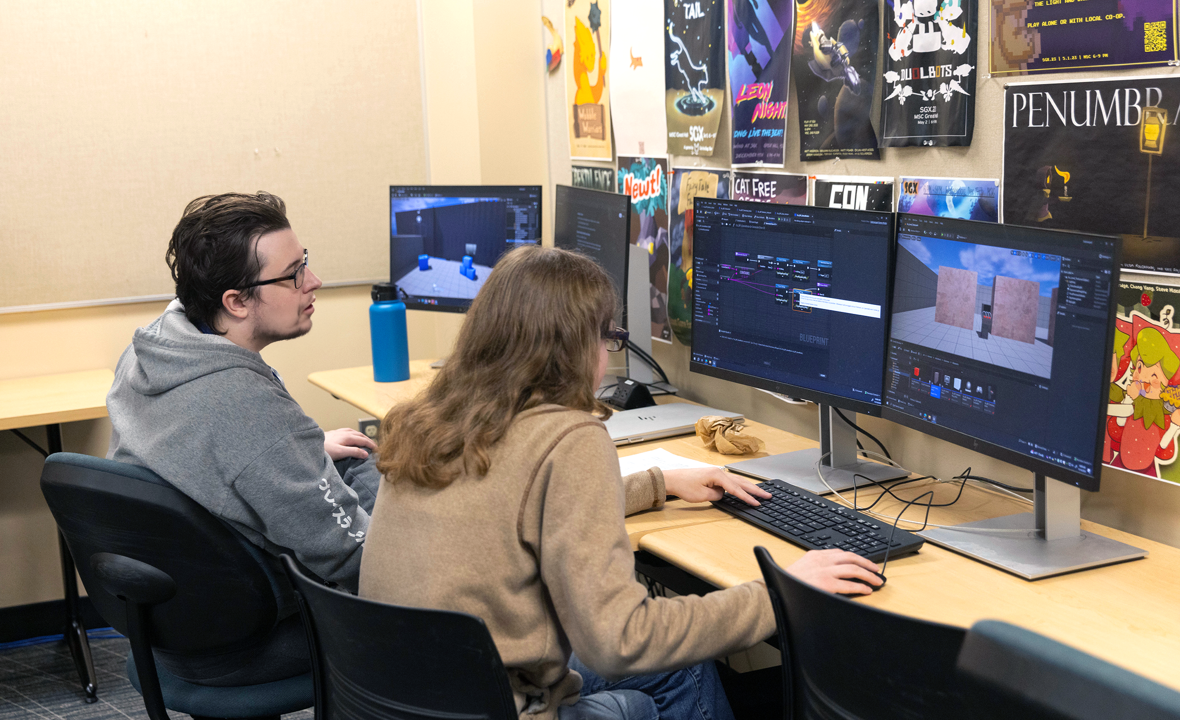 Two game design students investigate code for their original game.