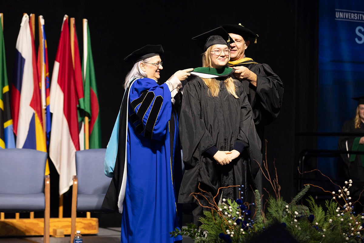 Graduate student receives hood