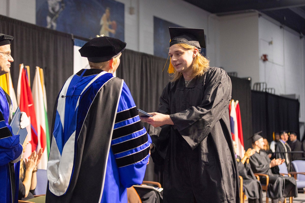 Man receiving diploma