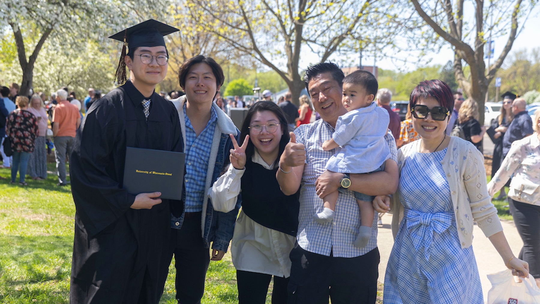 A family celebrates with their graduate at commencement