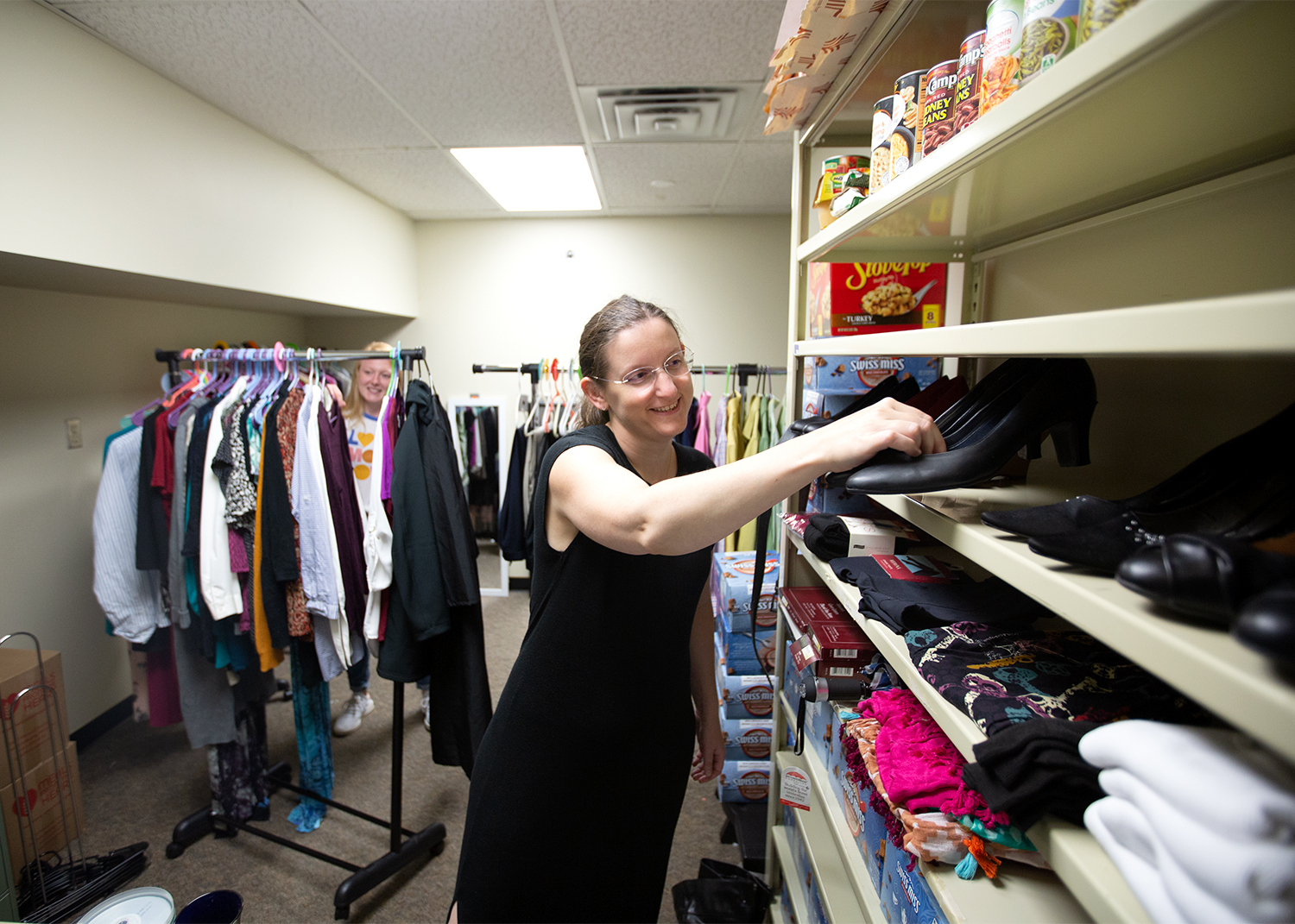 Sara Snyder places a pair of shoes in the career closet.