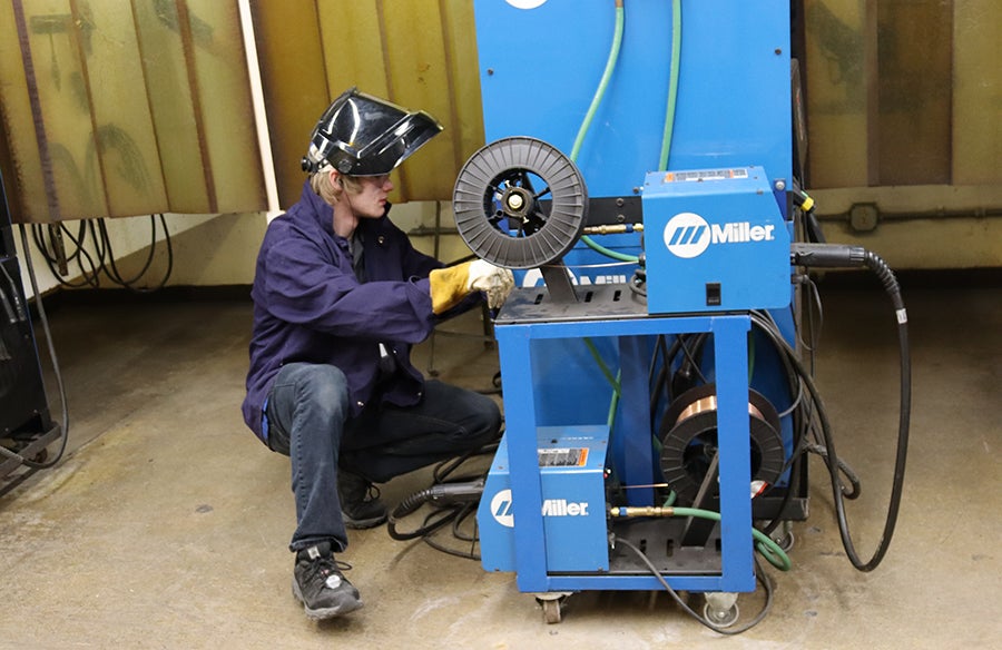 Adam Nelson, a senior at Wausau West, adjusts a welding machine during the Regional SkillsUSA competition.