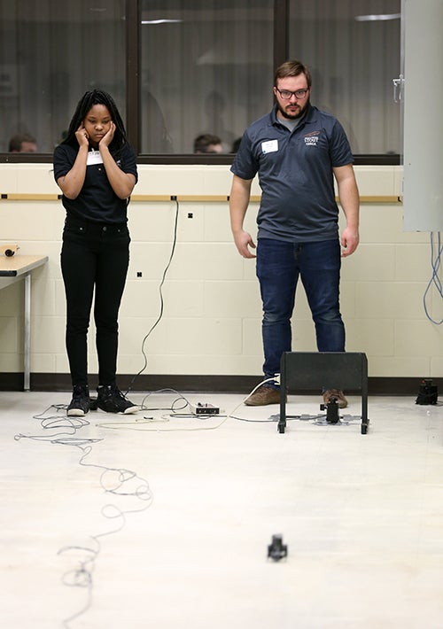 Azarria Martin reacts as her CO2 car races down a course at SkillsUSA