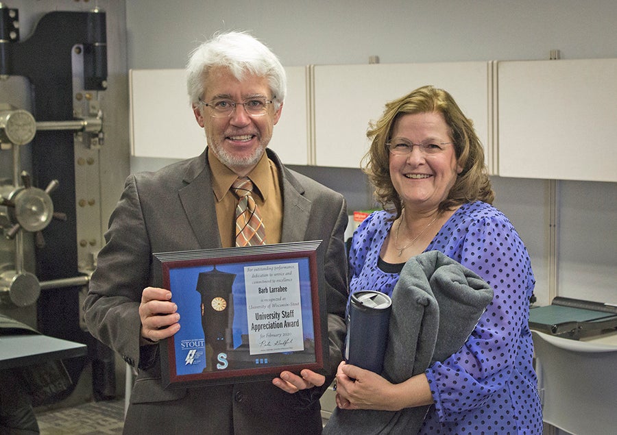 Interim Chancellor Patrick Guilfoile presents Barb Larrabee with the February University Staff Appreciation Award.