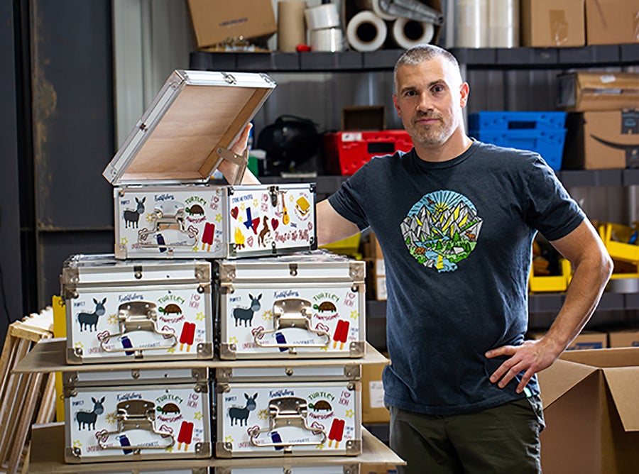 Mark Sieglaff, C&N vice president, inspects an order of custom minitrunks for Heart O’ the Hills Camp in Hunt, Texas.