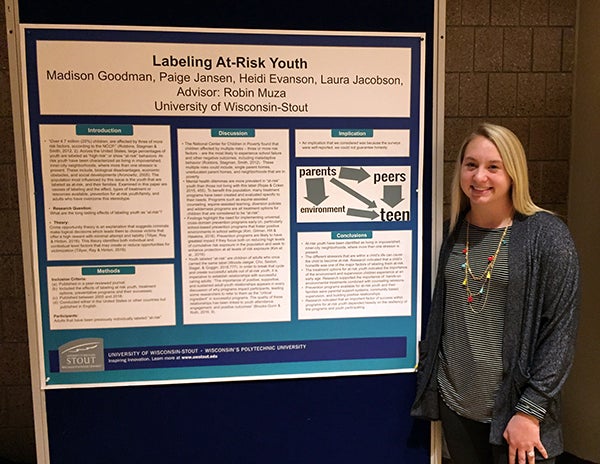 Heidi Evanson, who graduated Dec. 15, with a degree in human development and family studies, presents research on at-risk youth.