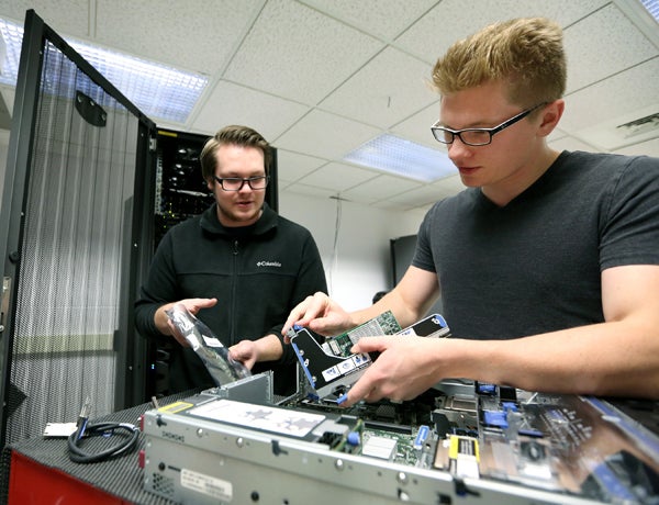 Pierce Lannue, left, and Stephen Felton work in the computer networking lab in UW-Stout’s Fryklund Hall.