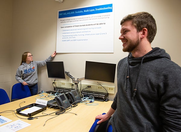 Nikki Ruf and Derek Muck look over one of the new Computer Networking and Cyber Security labs.