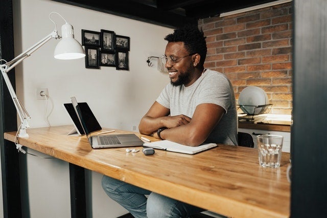 Person sitting at a desk with a laptop