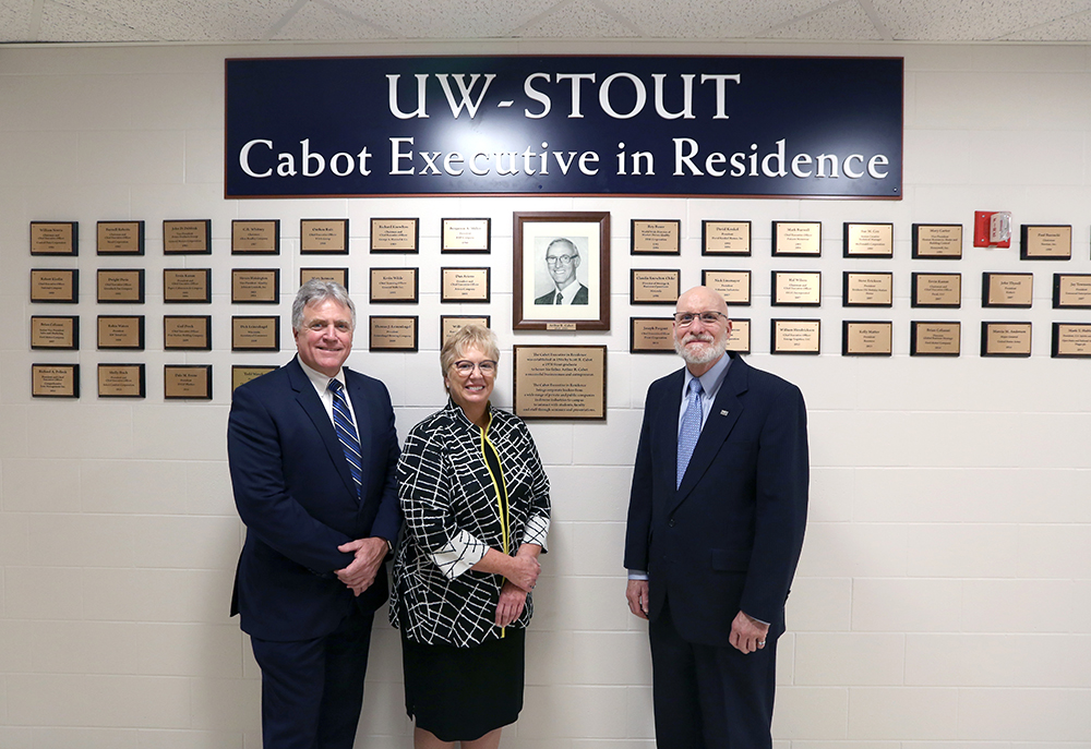 Denise Coogan, center, pictured with Chancellor Bob Meyer, at left, and Scott Cabot at the UW-Stout Cabot Executive in Residence Wall of Honor.