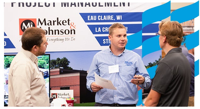 Students engage with industry recruiter at career conference.