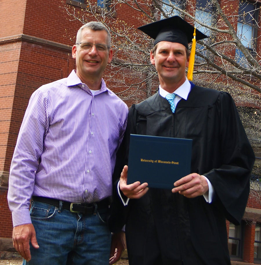 Jeff Coggins at right with Craig Yolitz who encourage him to return to college.