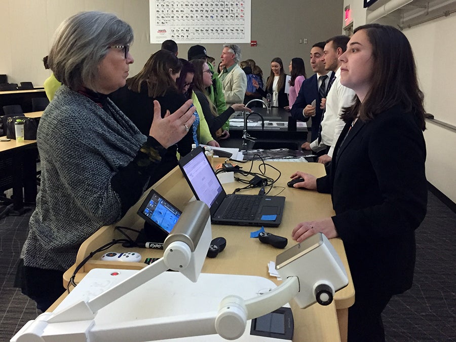 Deb Meyer, vice chair of the Bridge to Hope board of directors, listens to students after the presentation.