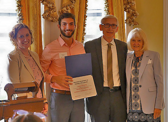 Cameron Hunter, second from left, receives a Champion of Change Award from Gov. Tony Evers, third from left.