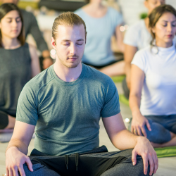 Man meditating in a class