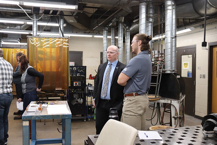 Wisconsin Secretary of Workforce Development Caleb Frostman, at left, helped judge the welding competition during the Regional SkillsUSA.