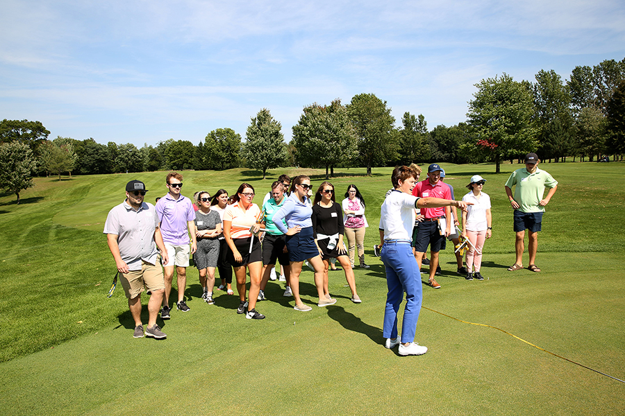 Associate Professor Kris Schoonover makes a point with her Sports Event Management class at Tanglewood Greens.