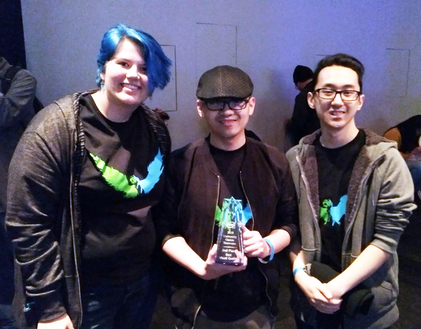 UW-Stout graduate Hue Vang, at center, shows the trophy for second place at the Intel University Game Showcase and Expo in San Francisco, with Kayla Techmeier, a UW-Stout game design-art student, and Vang’s brother, Chuewa Vang, a UW-Stout computer science-game design student who helped with the game.