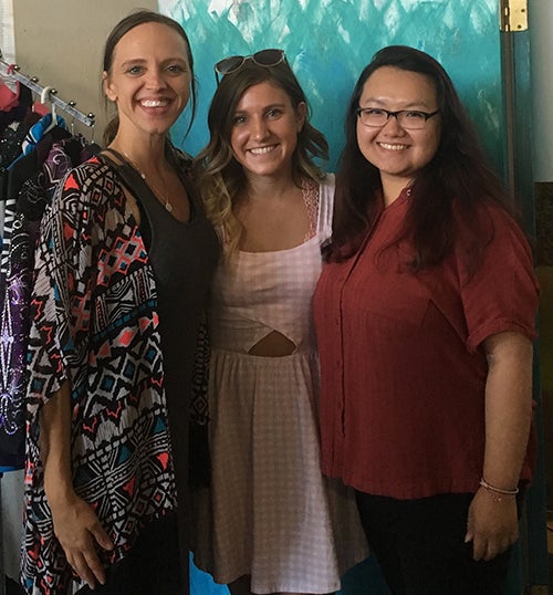 Sowle, at left, stands with interns Brooklyn Haas, in center, and Pakou Vang at the Minnesota Fair booth.