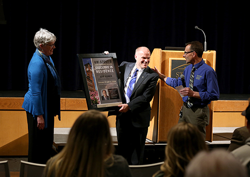 ​​​​Ylinen receives a plaque honoring him as a Executive in Residence from Deanna Schultz, associate professor in CTE, and Urs Haltinner, a CTE professor.