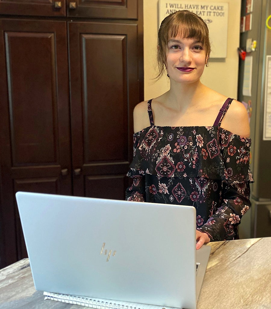 UW-Stout first-year student Jillian Chaltry with her laptop computer. UW-Stout innovated this year and has shipped laptops early to new students via UPS, due to COVID-19.