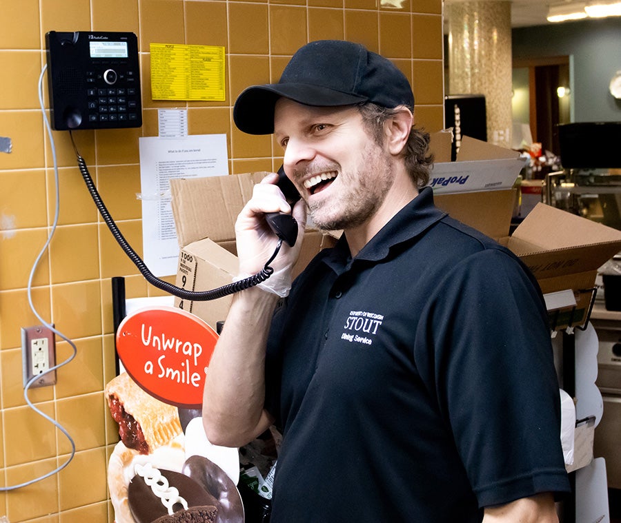 University Dining staff member John Arnold calls University Housing to tell them meals will soon be delivered to residence halls.
