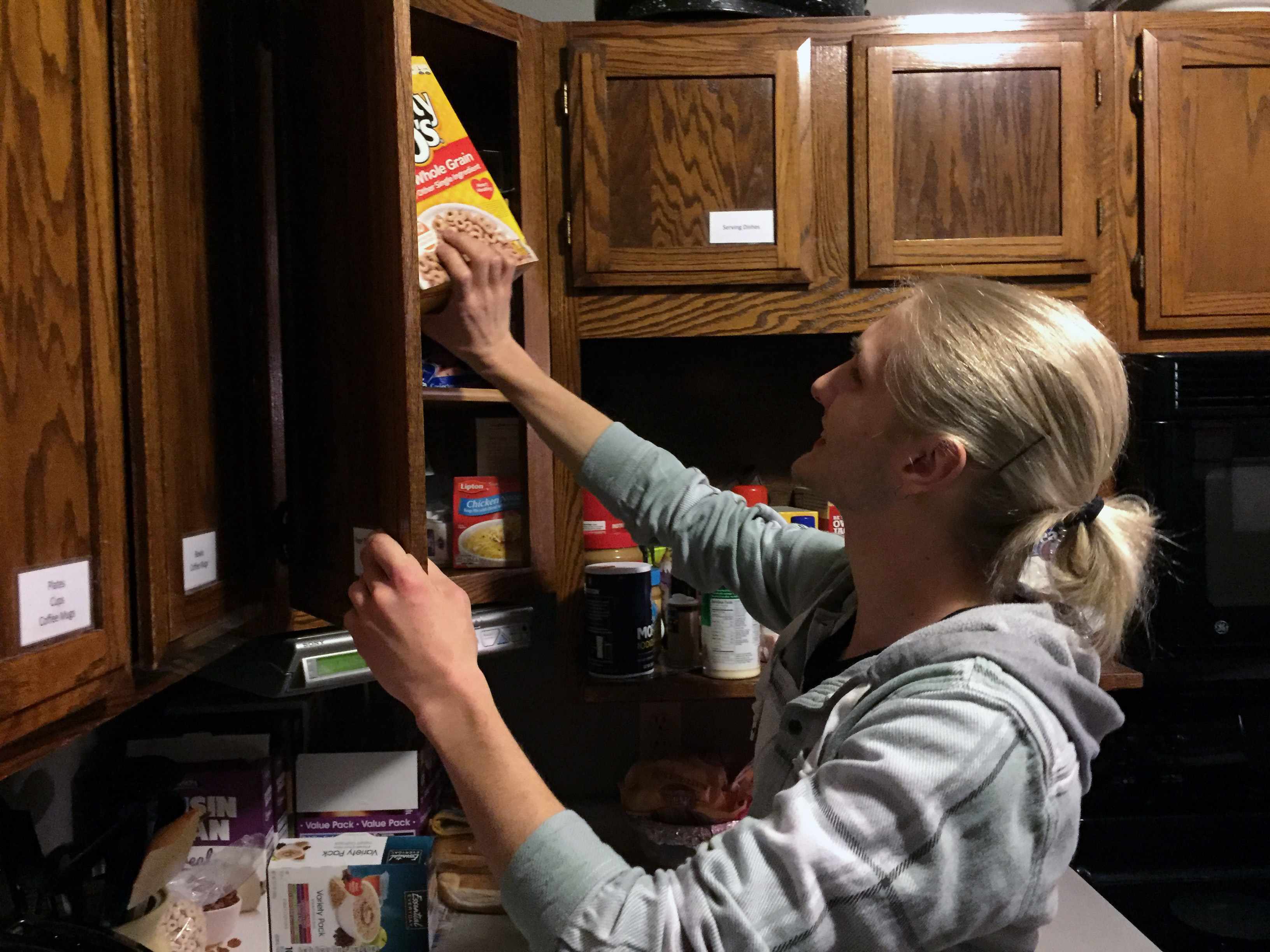 Justin Kalkes, a UW-Stout student, checks the cupboards and food supplies at Winter Haven during his volunteer shift at the overnight shelter in Menomonie.