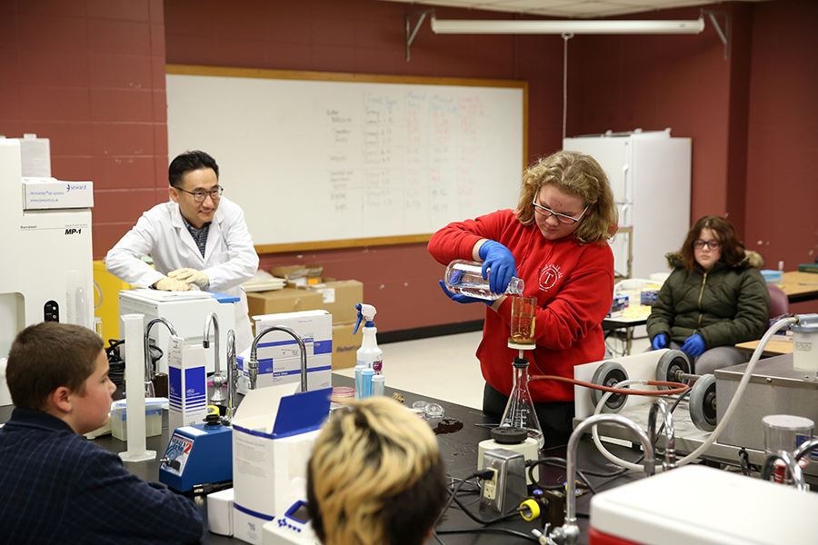 Stanley-Boyd Middle School student Kylee Hetchler tests drinking water during Stout Connects You STEM Festival with Taejo Kim, UW-Stout assistant professor in the department of food and nutrition. Hundreds of students took part in interactive displays and visited science labs at UW-Stout.