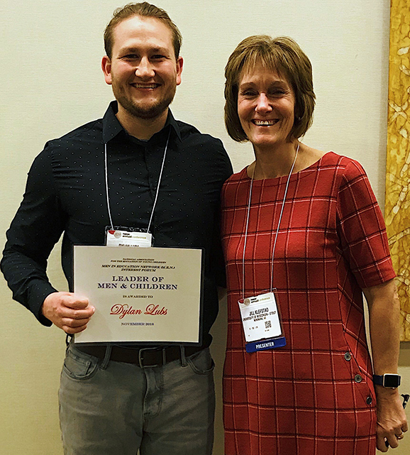 Lubs with Professor Jill Klefstad after receiving the national award given to up-and-coming strong male teachers.