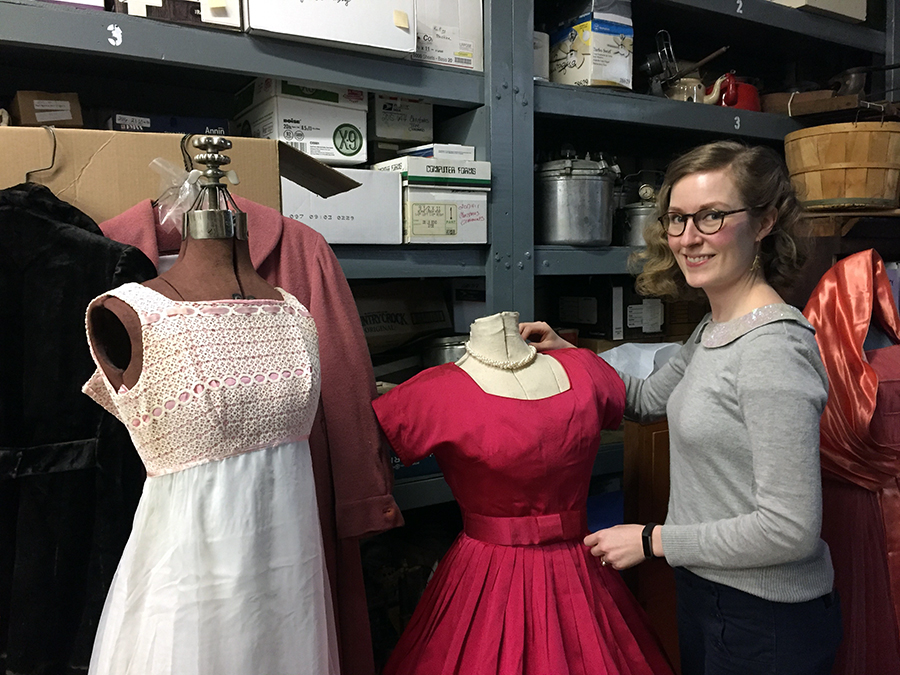 Rassbach Heritage Museum Director of Education and Programming Melissa Kneeland shows some vintage gowns that will be displayed at the Snow Ball.