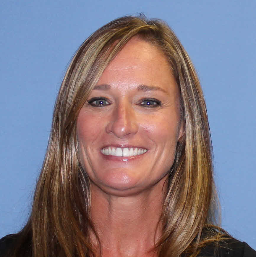 Molly Welch Deal is a white woman with long, straight hair. She is smiling at the camera and has a light blue background behind her.