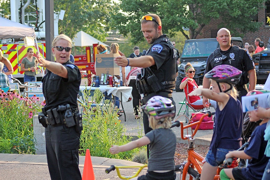 Healthier officers help keep the community safe. Menomonie police officers taught bicycle safety at a National Night Out event.