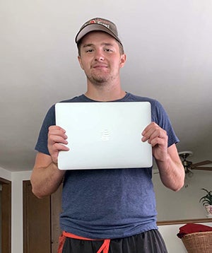 UW-Stout first-year student Noah Chaltry with his laptop computer.