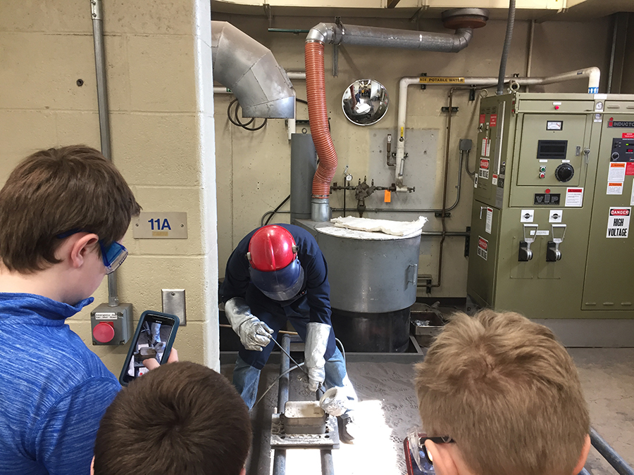 Pavel Bizyukov, assistant professor of engineering and technology, pours aluminum into a cast at the university foundry. Students were able to learn about the casting process during Stout Connects You.