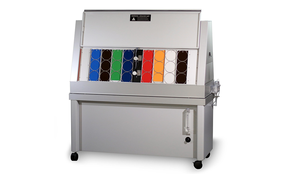 QUV Accelerated Weathering Tester with its front face open revealing various stressors to test material strength against environmental factors.