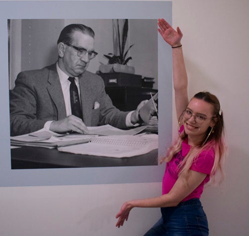 Rose Barker with a portrait of Merle M. Price