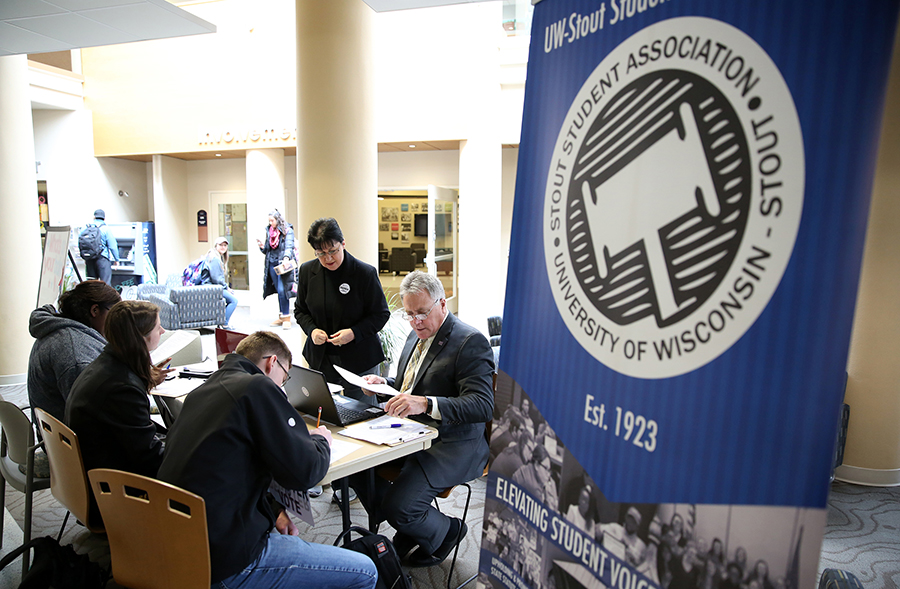 Stout Student Association members, joined by Chancellor Bob Meyer, hold a Rock the Vote registration event at the Memorial Student Center. 