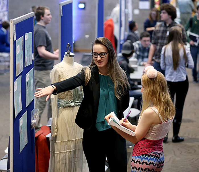 A student discusses her fashion research at a recent STEMM Expo at UW-Stout.