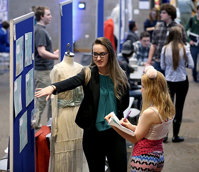 A student discusses her fashion research at a recent STEMM Expo at UW-Stout.